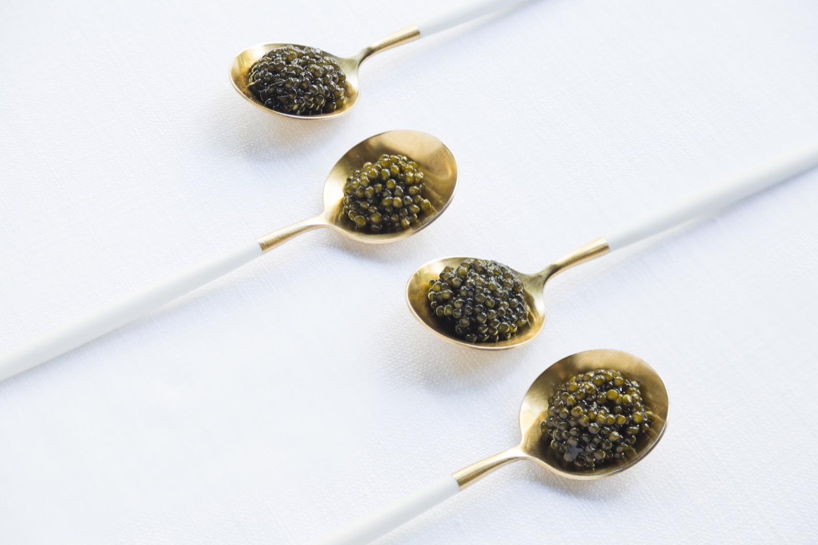 Caviar on gold spoons — JéJé Chaya premium bar selection