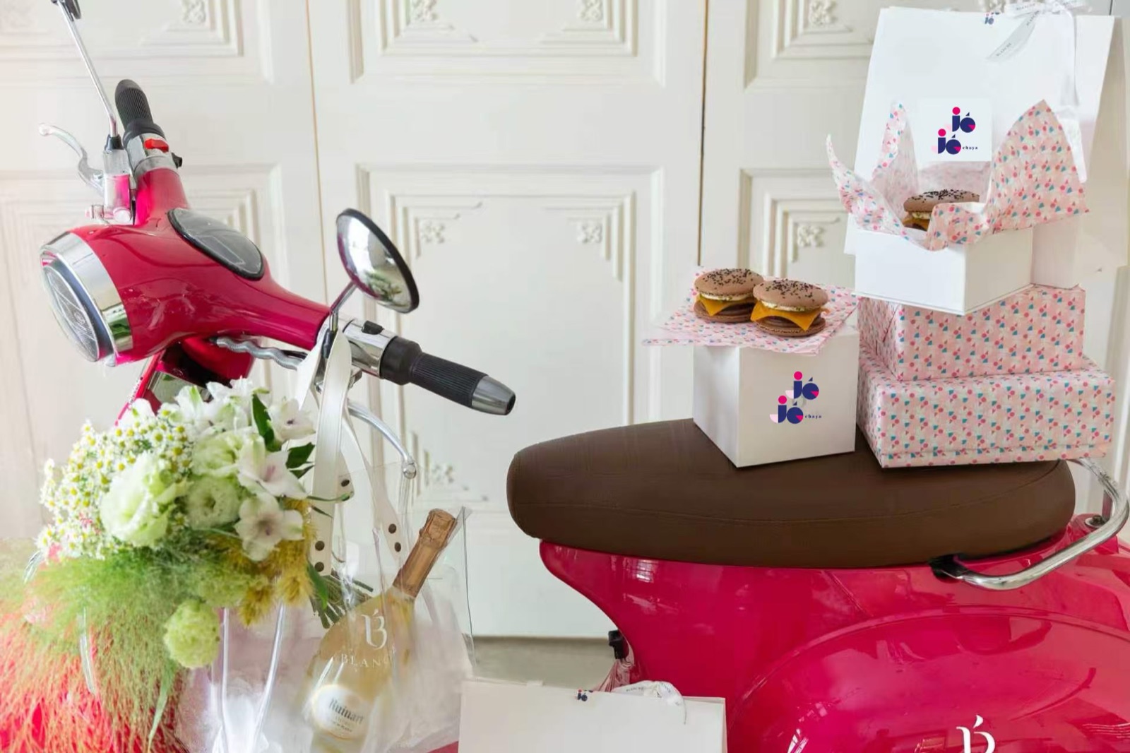 JéJé Chaya — pink Vespa with JéJé branded boxes, macarons, champagne and flowers
